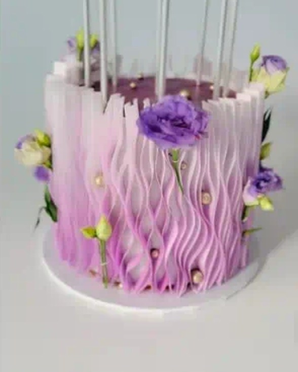 Lavender ombre cake with wavy sugar ruffles and fresh flowers